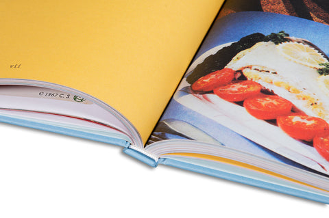 Close-up of the book cover for "Happier, Stupider Times" by Anthony Bourdain, featuring bold typography and a vibrant design.